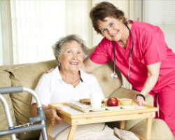 nurse giving nutritious food to an elderly woman