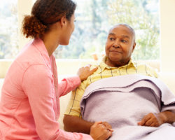 caregiver comforting elderly man