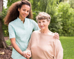 smiling elderly woman and her caregiver